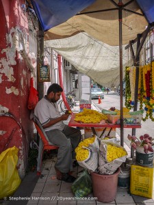 Man making Hindu flower garlands