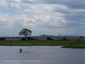 Man throwing a fishing net near Baticaloa, Sri Lanka